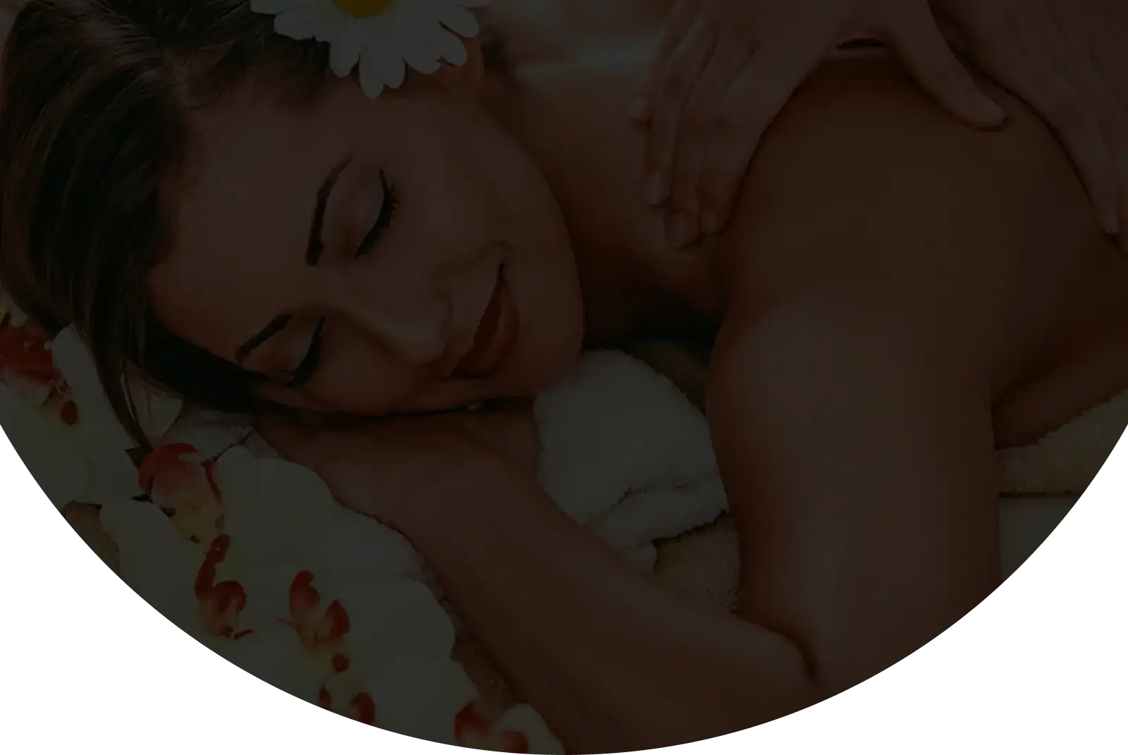 A woman receiving a back massage on a spa table.